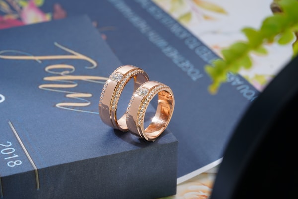 A couple of wedding rings sitting on top of a book