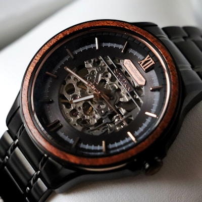 A close up of a watch on a white surface